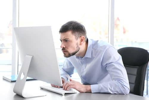 Man hunched over computer